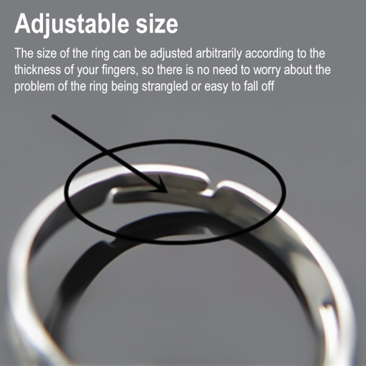 Adjustable open ring with dark blue heart-shaped gem on silver-toned band