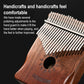 Wooden 17-tone kalimba close-up showing metal tines over sound hole