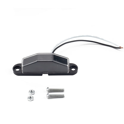 License plate light with black base, clear lens, mounting screws, and wire pigtail
