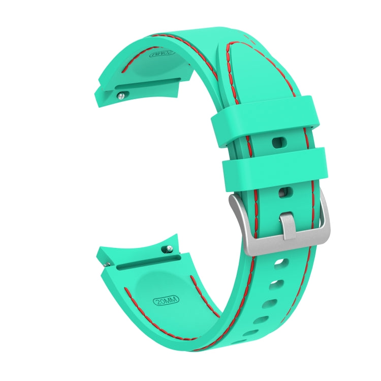 Teal silicone watch strap with red-stitched edges and metal clasp buckle