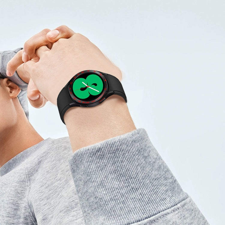 Smartwatch bezel ring attachment worn on wrist with black band and green clover dial