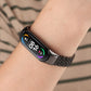 Black seven-bead stainless steel smartwatch strap worn on wrist