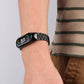 Black seven-bead stainless steel smartwatch strap on wrist