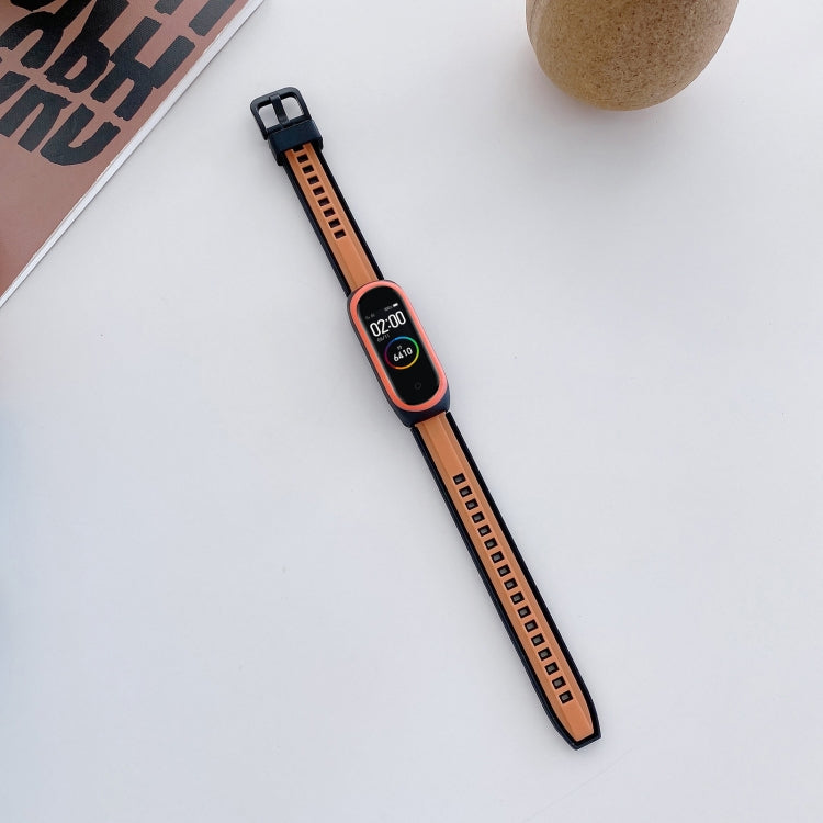 Orange and black silicone smartwatch wristband with adjustable holes and clasp
