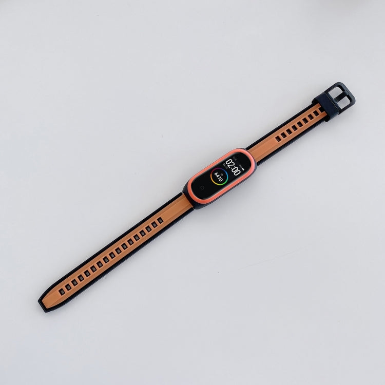 Orange and black silicone smartwatch band with centered watch face and strap holes