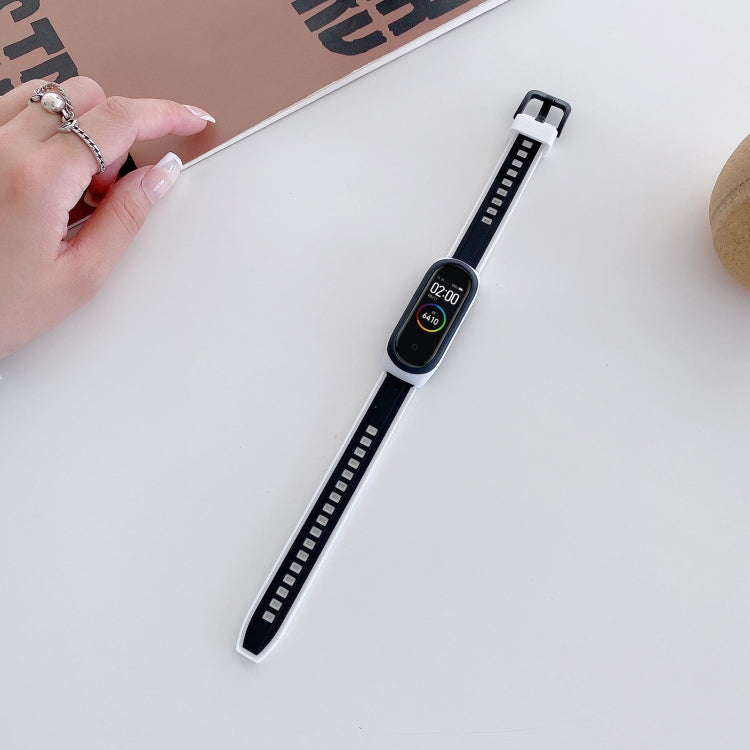 Black and white silicone smartwatch wristband with adjustable holes and buckle clasp