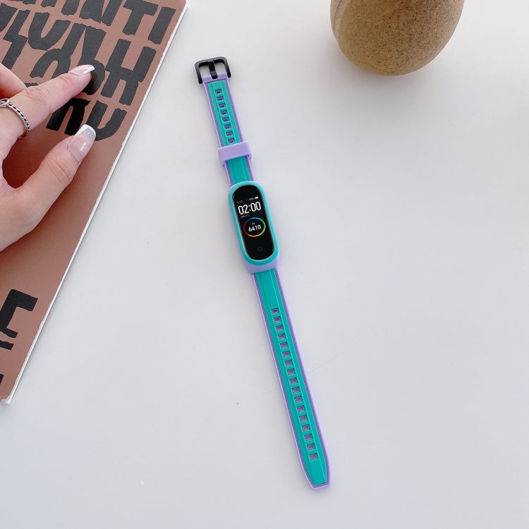 Blue and teal silicone smartwatch wristband with teal markers and adjustable holes
