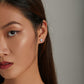 Heart moonstone stud earrings on model's ear with blue stone