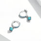 Pair of sterling silver hoop earrings with turquoise square pendants and blue side stones