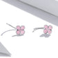 Sterling silver pink enamel flower hoop earrings, side view with thin curved band