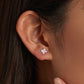 Sterling silver pink flower stud earrings with small three-petal enamel blooms on ear