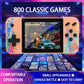 Pink handheld dual-player game console showing classic arcade games on the 3.5-inch screen