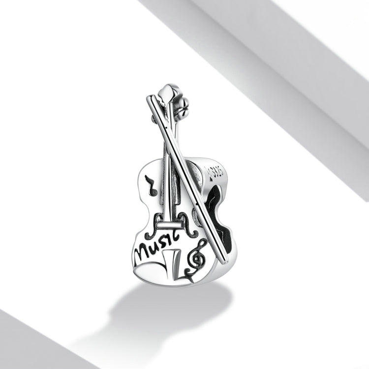 Sterling silver vintage violin charm bead with engraved music notes, angled view