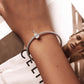 Sterling silver violin charm bracelet on wrist with mesh chain and clasp