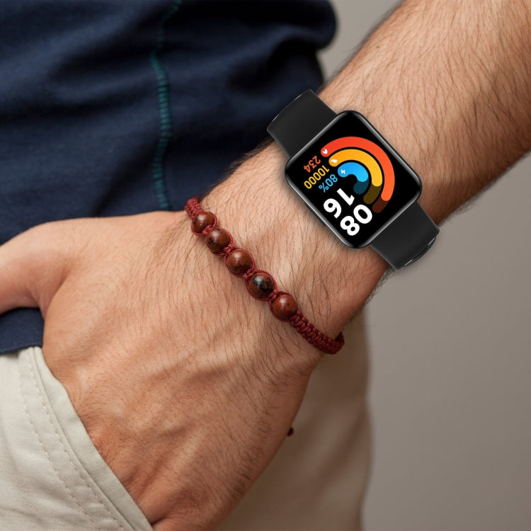 Two-color silicone watch band on wrist, black strap with rectangular clasp
