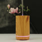 Wooden essential oil humidifier with light wood body, purple LED ring, mist vapor
