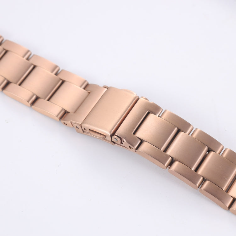 Rose gold three-bead steel watchband detail, clasp hardware and connector links