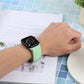 Mint green woven nylon braid watchband worn on wrist