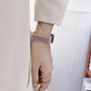 Gray nylon loop watchband with black clasp on wrist