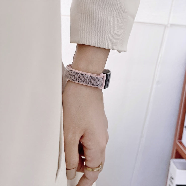 Gray nylon loop watchband with black clasp on wrist