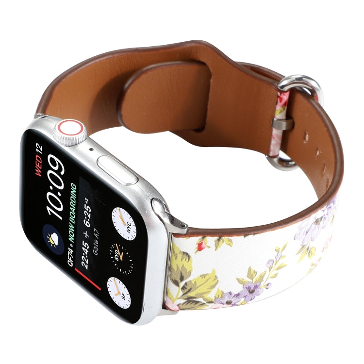 Floral watch strap with white floral pattern and brown leather interior, silver metal buckle.