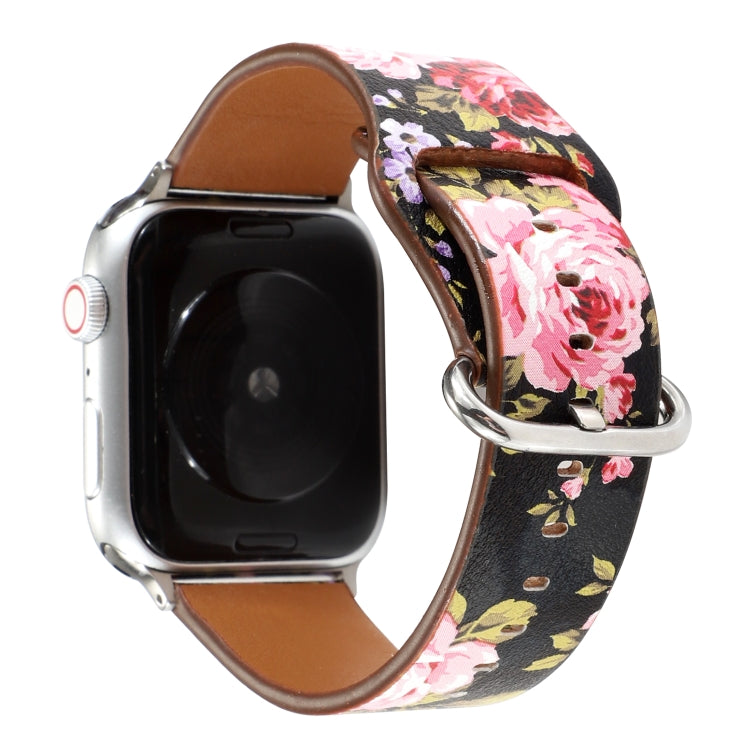 Floral watch strap with black and pink flower pattern, brown leather back, silver pin clasp.