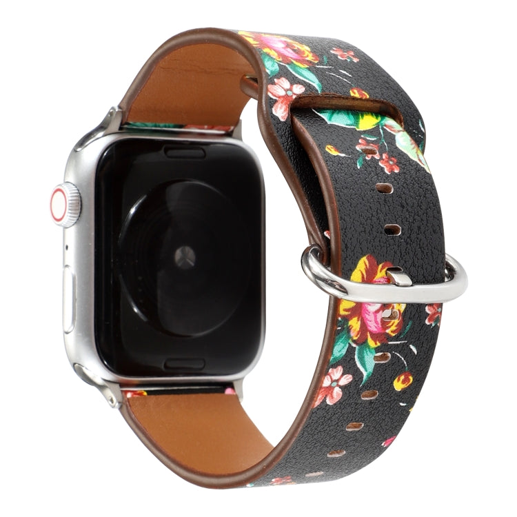 Floral watch strap with black floral print and colorful blooms, brown leather interior, metal clasp.