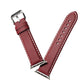 Red-brown leather watch strap with metal buckle and white contrast stitching across links