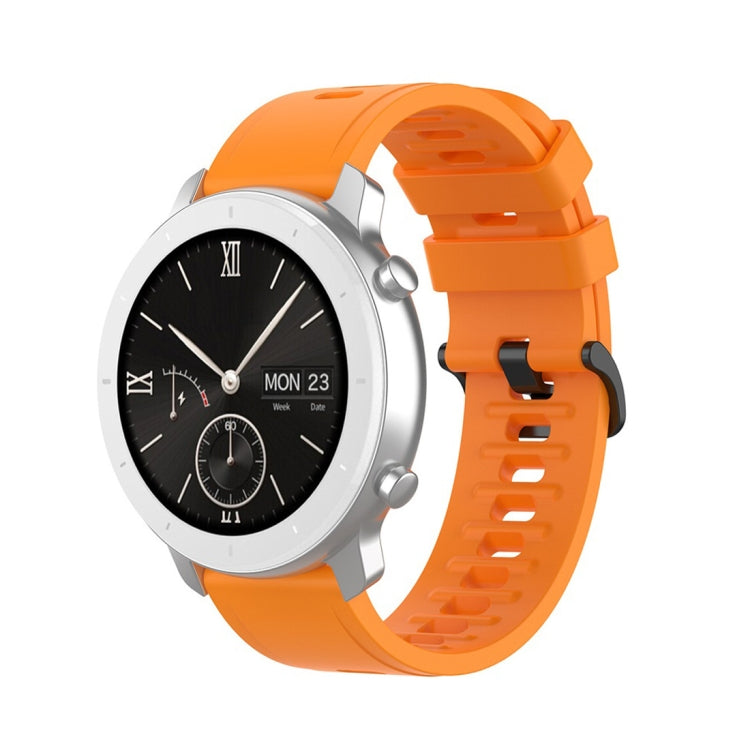 Orange silicone smartwatch replacement strap with perforated holes and quick-release lugs