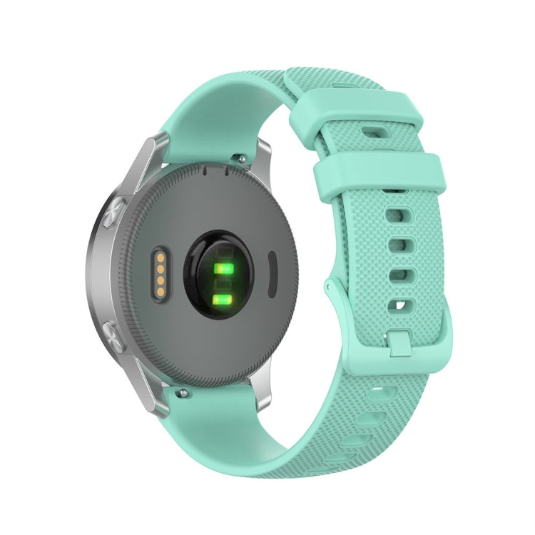 Silicone smartwatch replacement strap in mint green, textured band with multiple adjustment holes