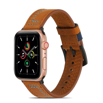 Brown matte leather watch band with blue strap keeper and perforations