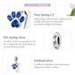 Sterling silver dog paw bone charm with blue CZ paw and oxidized silver details