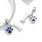 Silver charm pendant set with blue dog paw and bone on a chain bracelet