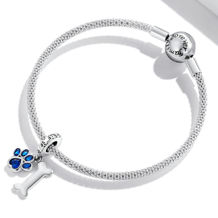 Sparkly silver chain bracelet with dog paw and bone charm and blue CZ accents