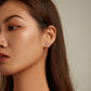 Zircon cluster ear stud on model’s ear with pink center and multicolor sparkle stones