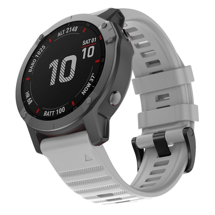 Gray silicone watch band with adjustable buckle and textured strap holes.