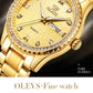 Close-up of gold-tone quartz watch dial with crystal markers and rhinestone bezel
