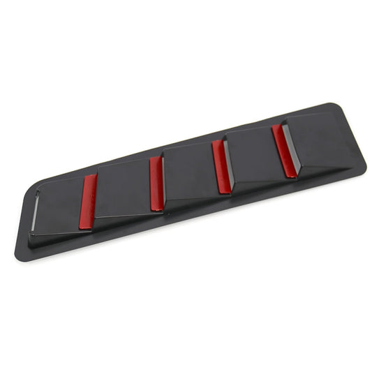 Black hood vent louver trim plate with raised vent fins and red accents