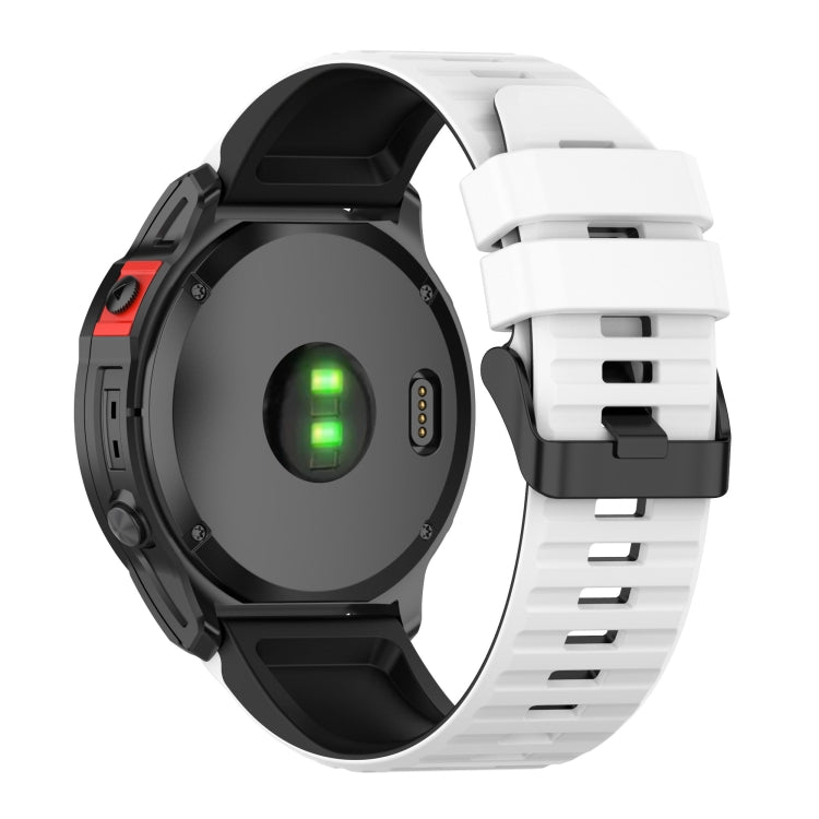 Two-tone silicone watch band with white strap and black clasp on a smartwatch