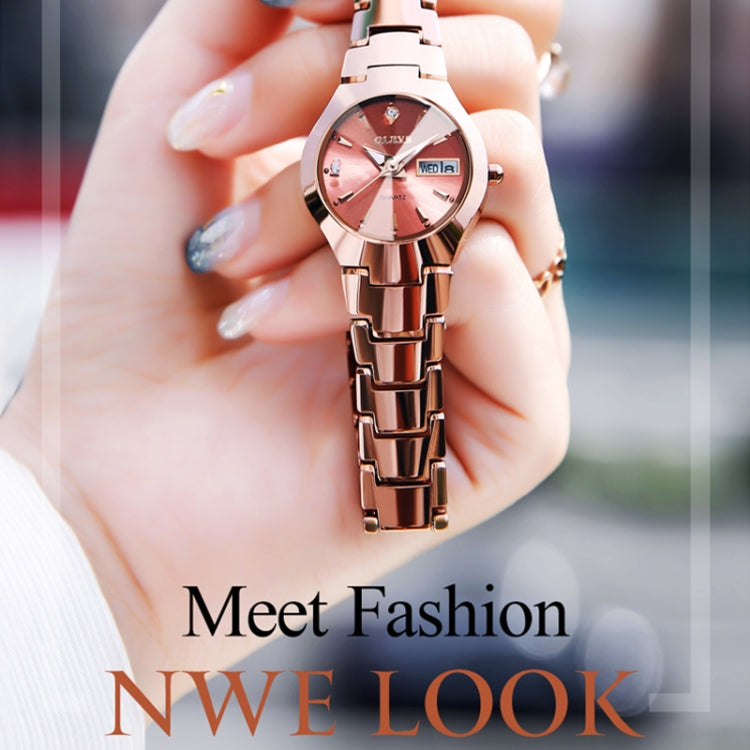 Rose gold tone quartz wristwatch with pink dial, luminous markers, and metal link strap