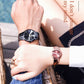 Two couple watches on wrists: black dial and rose gold pink dial with link bracelets