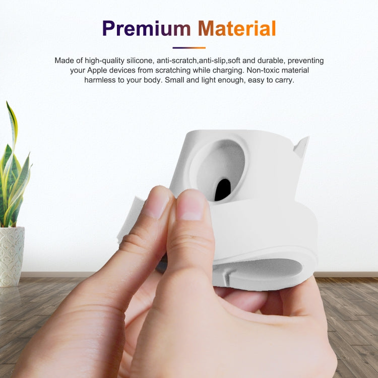 Hand holding a white silicone charging holder with Apple Watch magnetic charging area