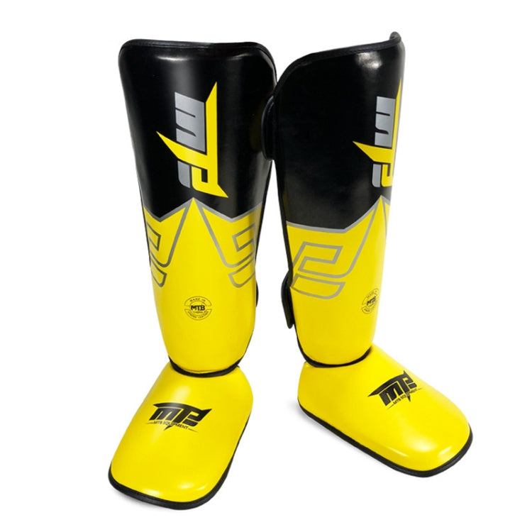 Yellow Thai boxing shin guards with padded ankle area and black side panels