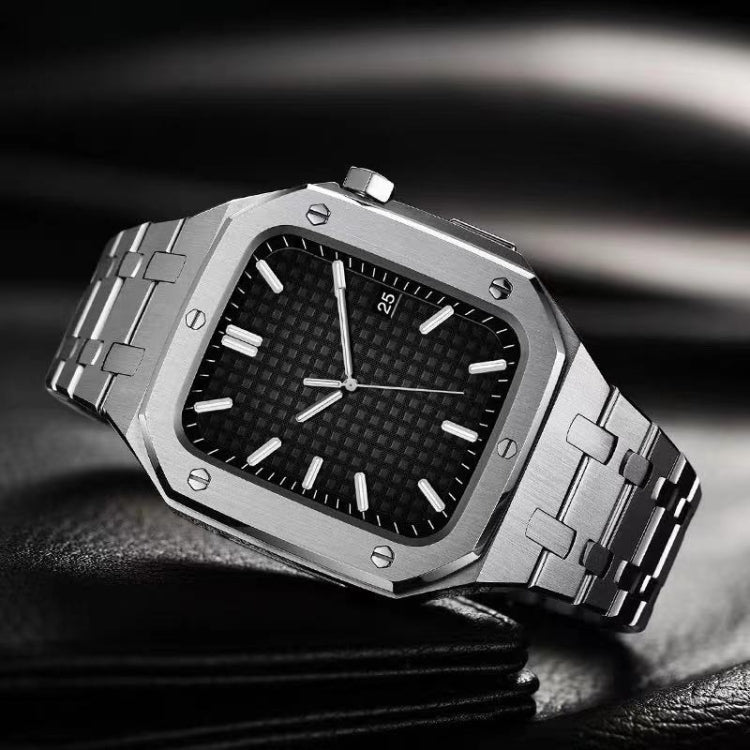 Silver metal watch with black dial and integrated link bracelet, angled close view