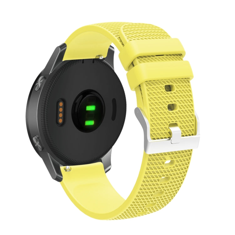 Silicone watch strap with textured pockmarked surface and silver buckle, yellow band