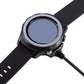 Watch placed on black cradle charger with charging cable connected