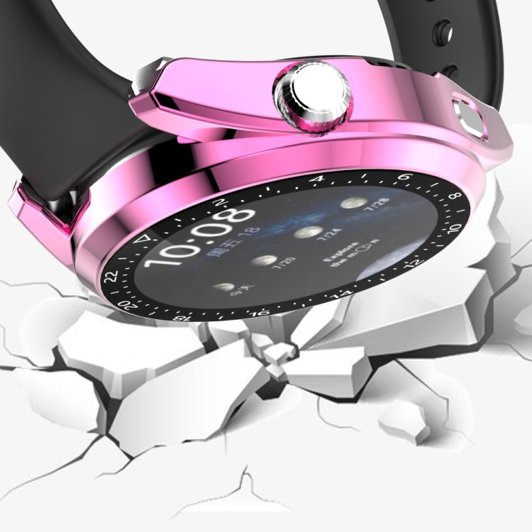 Pink electroplated watch case with black bezel and crown on a cracked base