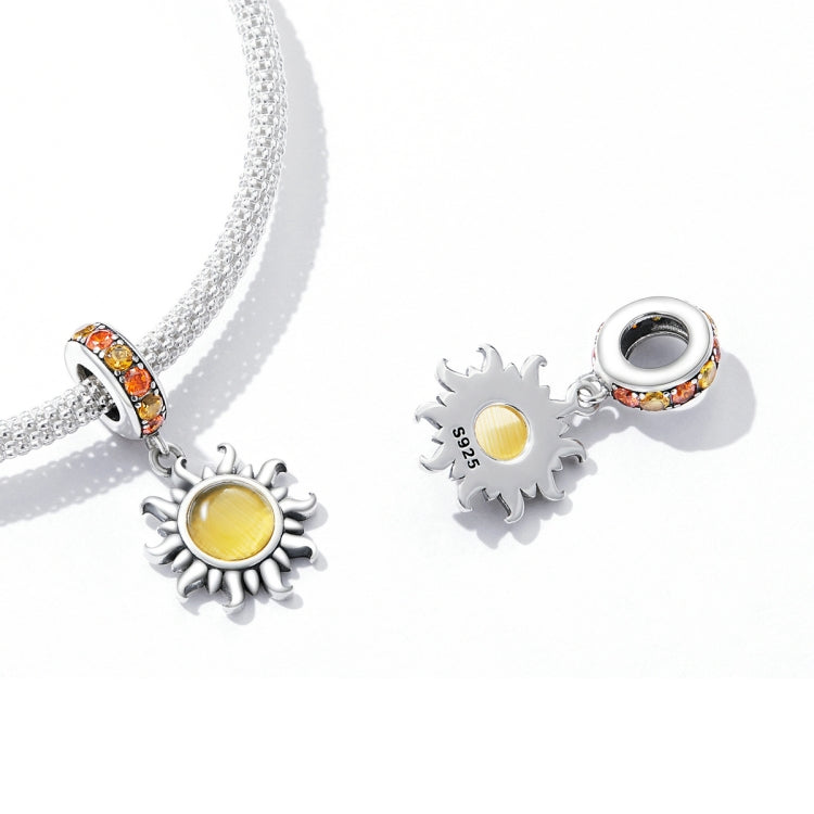 Sterling silver bracelet charms set with two sun pendants and yellow centers