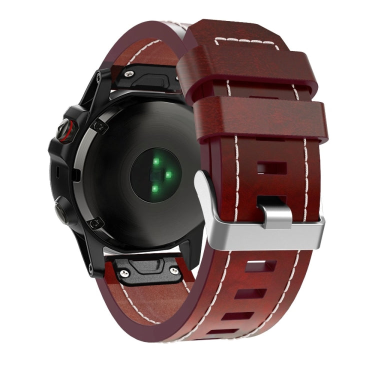 Burgundy leather quick-release strap with metal clasp and white stitching on Garmin watch