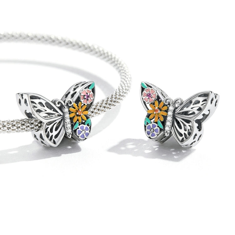 Silver chain bracelet with butterfly flower charm and multicolor enamel petals